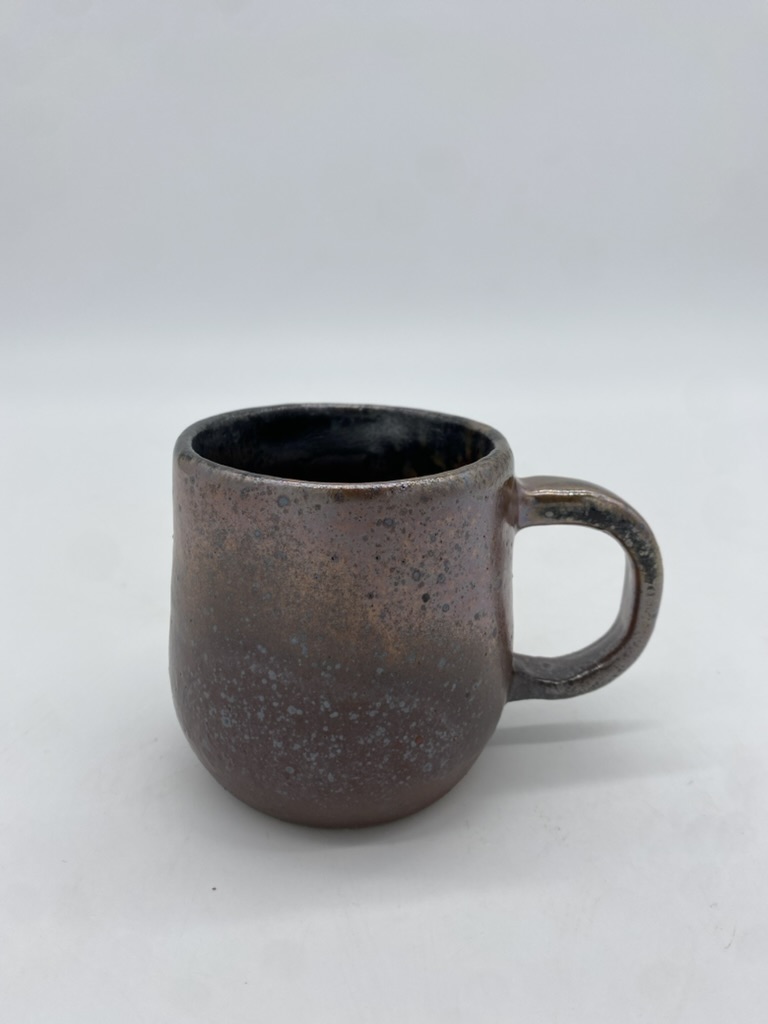 A copper-colored stoneware mug.