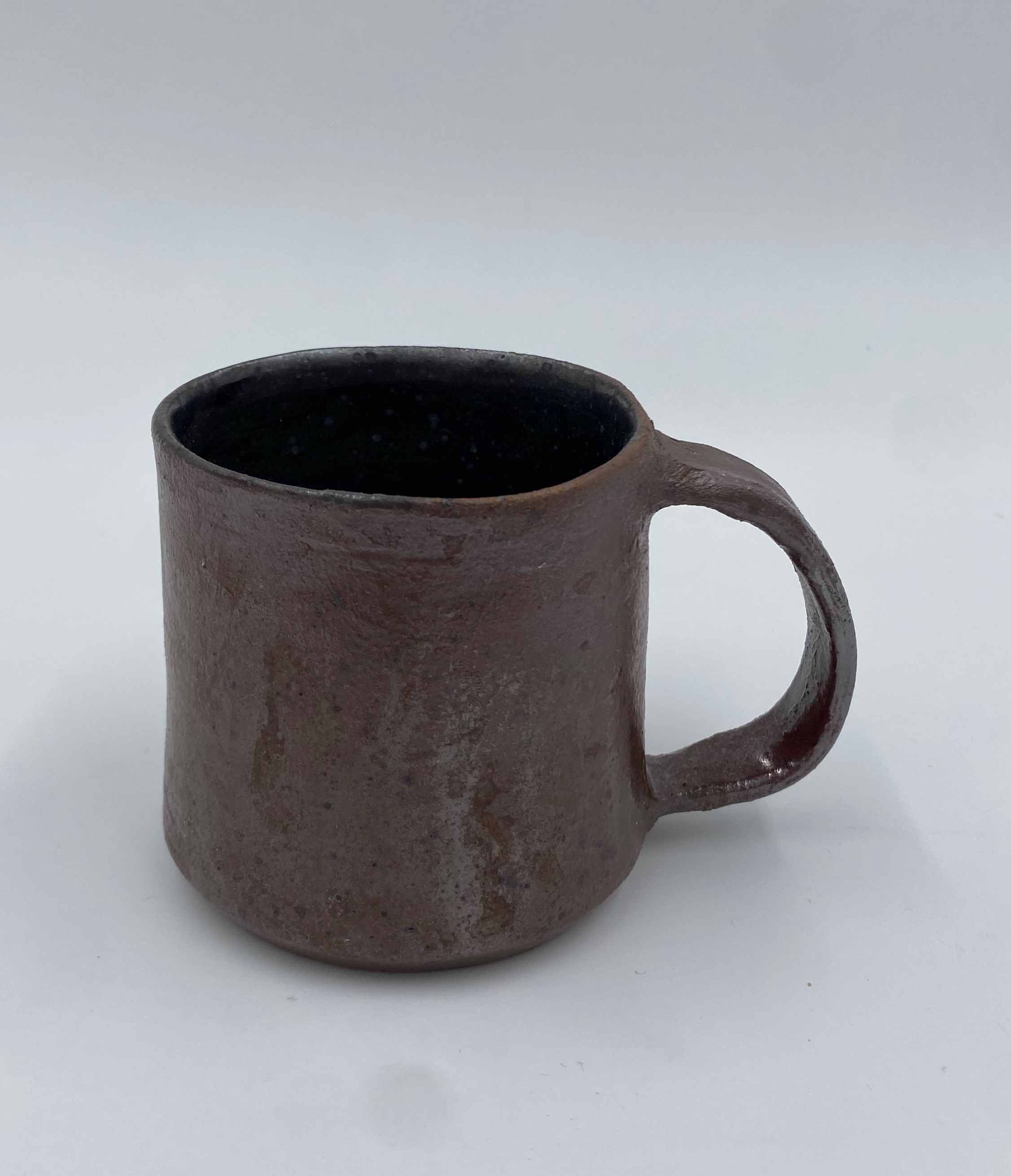 A metallic red mug with a black inner glaze.