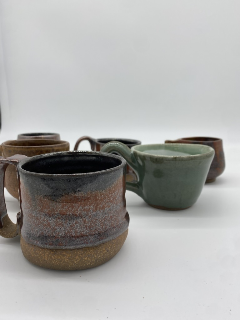 A collection of stoneware mugs.